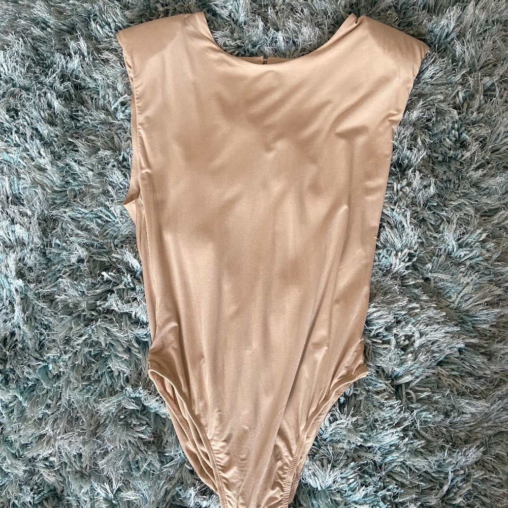 One piece with small shoulder pads attached